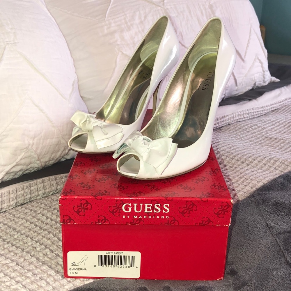 White PTO guess heels with a bow on front of them.